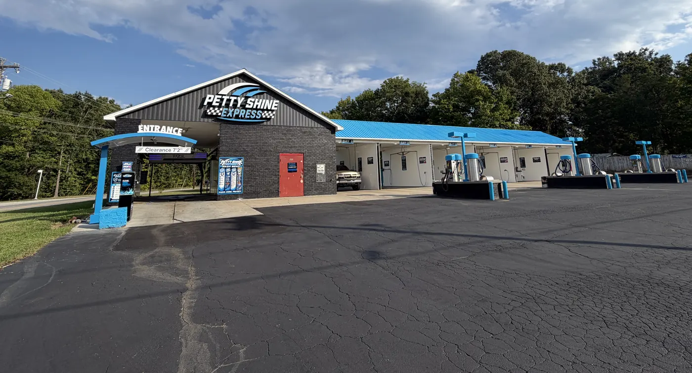 Petty Shine Express building with the blue roof, entrance and self-serve bays under a summer sky